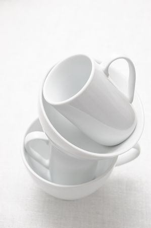 Arrangement of white ceramic dish on a white tableclothの写真素材