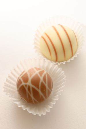 Two candy in paper tartlet on a white backgroundの写真素材