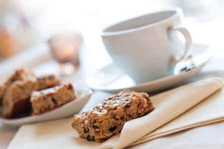 Close-up of home-made bisquits and a cup of tea on the table in the morningの写真素材