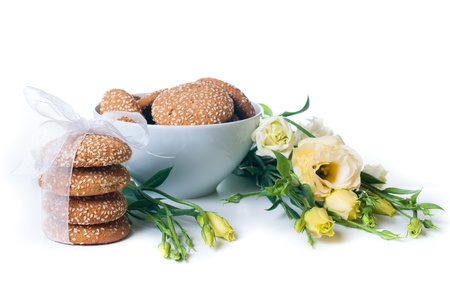 delicious cookies and a bouquet of yellow Eustomas on a white backgroundの写真素材
