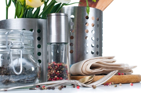 Kitchen objects, cookware, tableware, flowers and spices on a white background Kitchen objects, cookware, tableware, flowers and spices on a white background