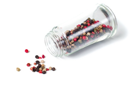 mixture of different peppers sprinkled from a can on a white backgroundの写真素材