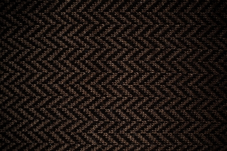 Texture of brown knited scarf with ornament, close-up