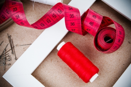 Tools for sewing and handmade  thread, pins on brown paper の写真素材
