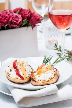 Holiday appetizer, toast with cheese, pepper and rosemary on the festive table, close-upの写真素材