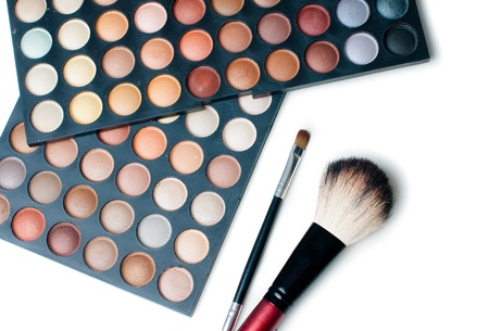 Palette of colorful eyeshadows and make-up brushes, close-up, isolatedの写真素材