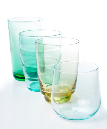 Four different multi-colored vintage glasses on a white background, isolatedの写真素材