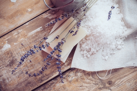 Natural soap, lavender, salt, cloth, old cans on a wooden board, rustic hygiene items for bath and spa の写真素材