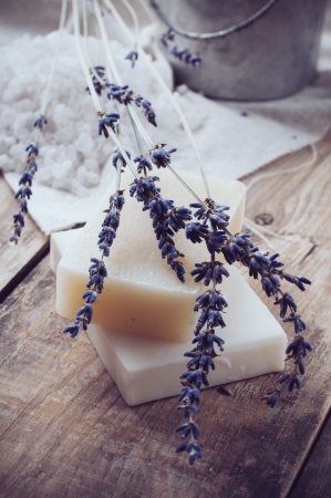 Natural soap, lavender, salt, cloth, old cans on a wooden board, rustic hygiene items for bath and spa の写真素材