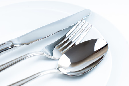 Shiny new cutlery, silverware close-up on white background
