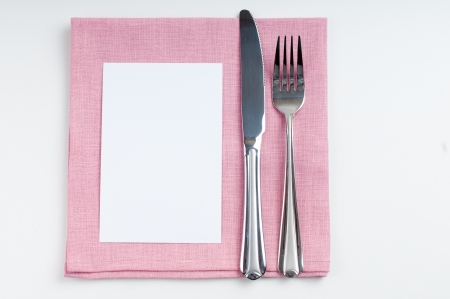 Shiny new cutlery, silverware and cardboard card close up on white backgroundの写真素材