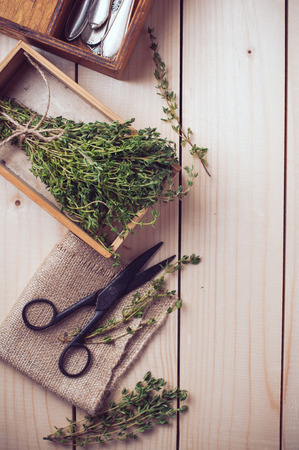 Rustic kitchen still life, dried herbs, old boxes and vintage scissors on a wooden table, home backgroundの写真素材