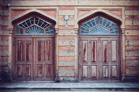 Two brown wooden doors of an old building in Ukraine, Europe.の写真素材