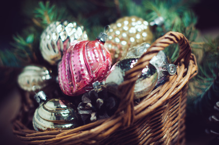 Vintage Christmas decorations in a wicker basket, Christmas gift in retro styleの写真素材