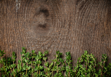 thyme herb on an old wooden board.の写真素材