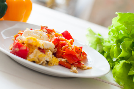 Home breakfast, sweet red pepper spices and fried egg in a plate. Simple home cookingの写真素材