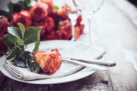 Vintage table setting with glasses and cutlery on an old wooden board, wedding table decorの写真素材