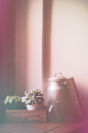 Vintage still life, antiques on a brown wooden windowsill.