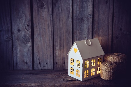 Cozy vintage home decoration: warm interior night light on an old wooden board background.の写真素材