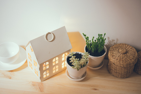 Beautiful vintage home decorations: flowers and decorative objects on the shelf by the wall. House decor background.の写真素材