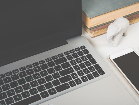 Realistic modern work space with laptop and office objects on a table closeup