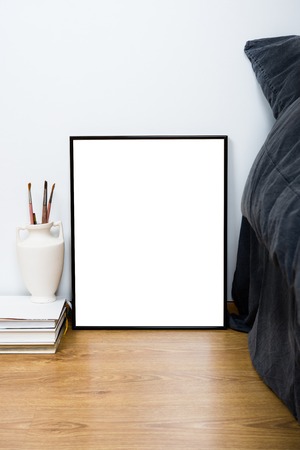 Empty blank classic black frame on a floor, minimal home bedroom interior decor, painting art poster...