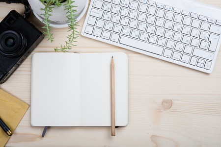 Photographers workplace tabletop, styled hipster's workspace, white computer keyboard and film camera, office desk top view with copy spaceの写真素材