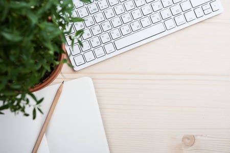 Styled tabletop, hipster's workspace, white computer keyboard and office objects, work desk top view with copy spaceの写真素材