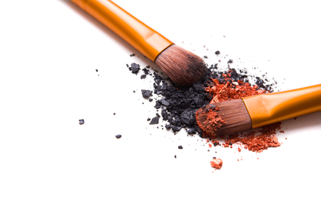 Professional makeup brushes set and loose powder eyeshadows isolated on white background,  cosmetic tools macro shotの写真素材