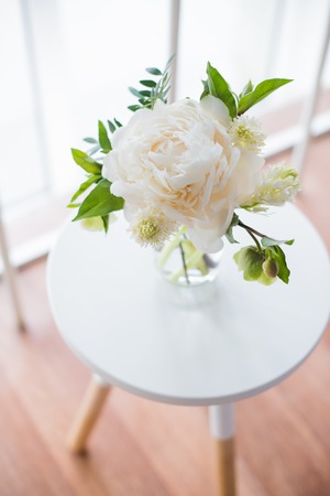 white peony flowers on coffee table in white room interior, brigの写真素材