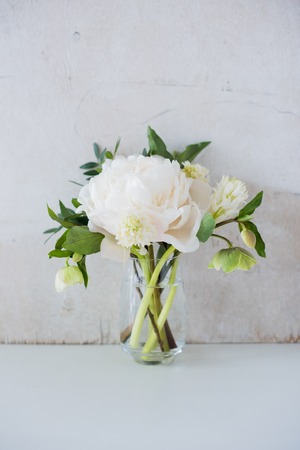 white peony flowers on coffee table in white room interior, brigの写真素材