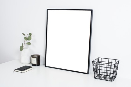 white office interior, stylish work table space with poster artwの写真素材