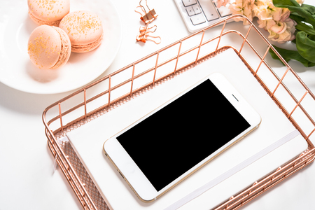 Feminine table decoration with orange macaroons, flowers and smaの写真素材