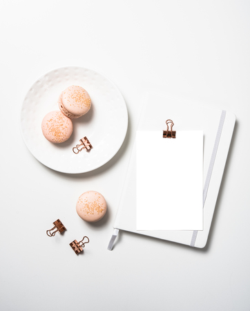 Social media flat lay with orange macaroons and postcard mock upの写真素材