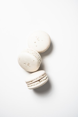 Three beige white macaroon cookiesの写真素材