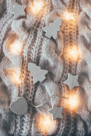 Winter holiday Christmas decorations, white wooden toys and knit