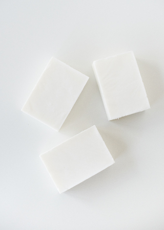 White handmade soap bars on white table