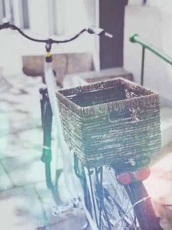 Stylish city bicycle with wickered basket on streetの写真素材