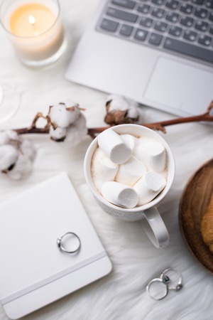 Cozy winter bloggers white work space with laptop, coffee with mの写真素材