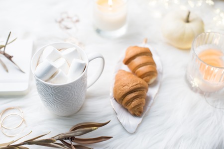 Cozy winter bloggers white work space with laptop, coffee with mの写真素材