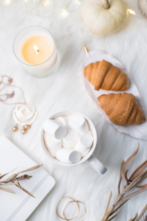 Cozy winter bloggers white work space with laptop, coffee with mの写真素材