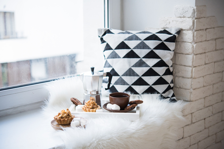 Cozy winter home arrangement on windowsill, coffee and cookies oの写真素材