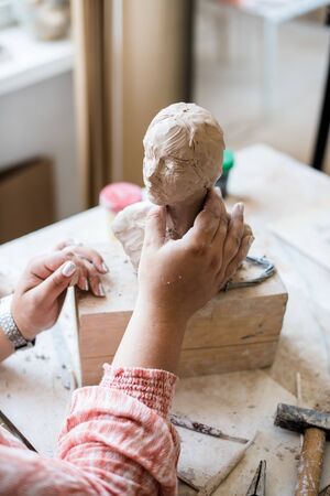 Lady sculptor working in her studio, ceramis artists handsの写真素材
