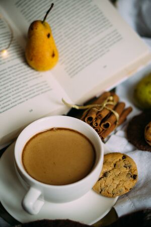 Cozy home weekend arrangement, warm bedroom decorations with coffee, wool blanketの写真素材