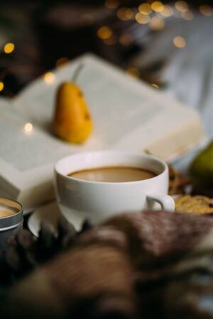 Cozy home weekend arrangement, warm bedroom decorations with coffee, wool blanketの写真素材