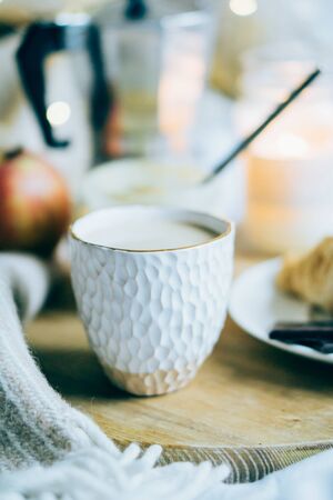 Beautiful white handmade ceramic cup in real home interiorの写真素材