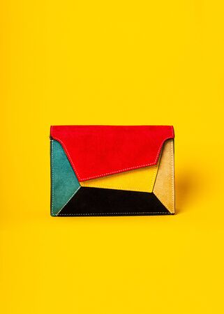 Colorful ladys bag, womans purse on yellow flat backgroundの写真素材