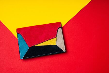 Colorful ladys bag, womans purse on red and yellow flat backgroundの写真素材