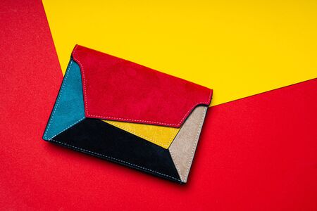 Colorful ladys bag, womans purse on red and yellow flat backgroundの写真素材
