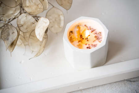 Home decoration with burning aromatic candle, white interior decorの写真素材